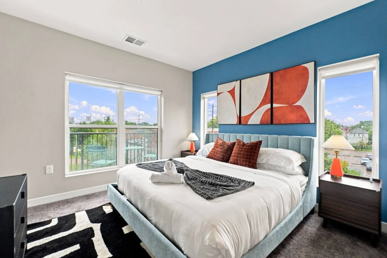 Bedroom with blue headboard and city view