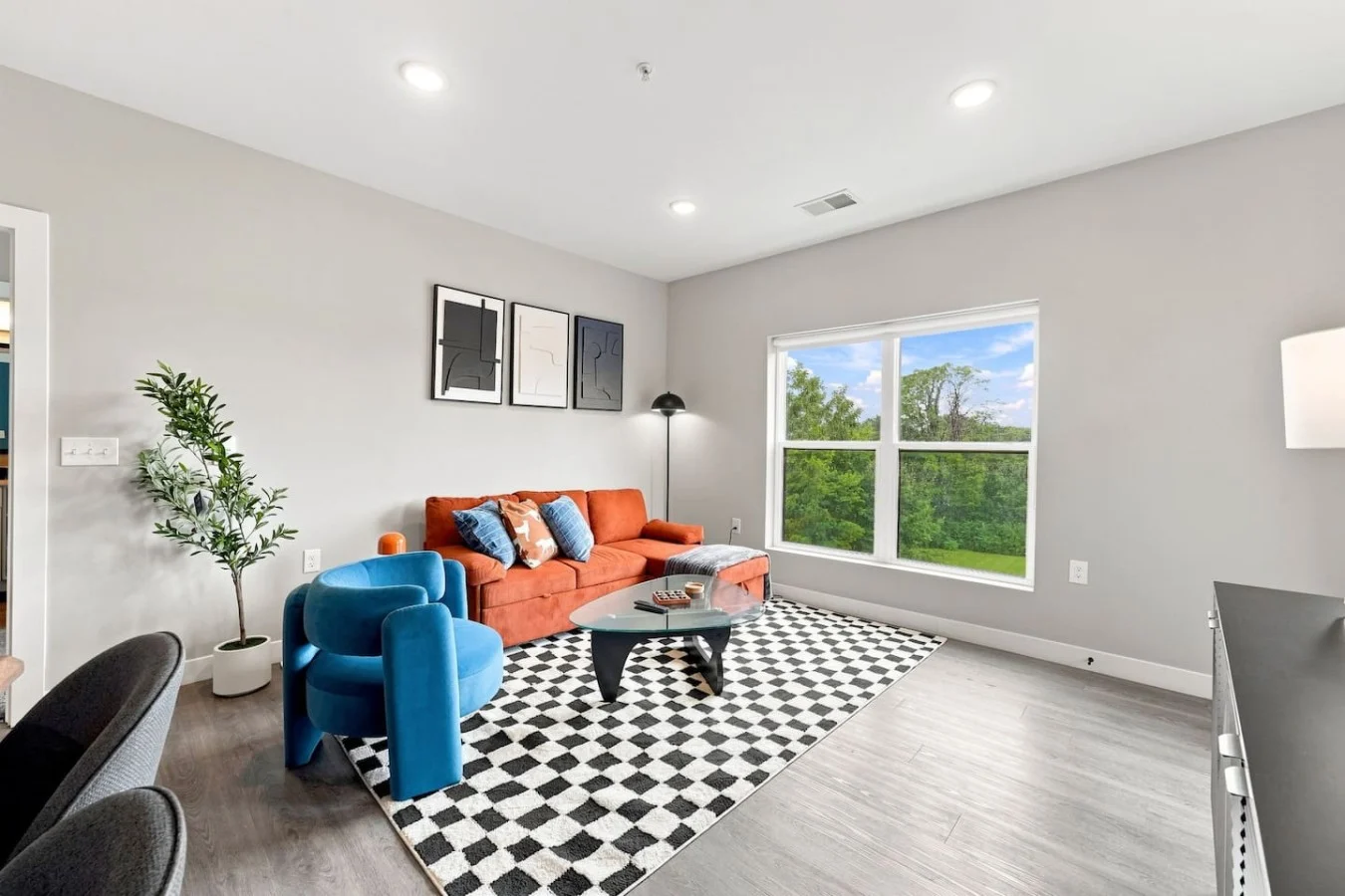 Furnished living room with orange sofa