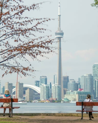 Three women enjoying autumn afternoon on Toronto Island with city views